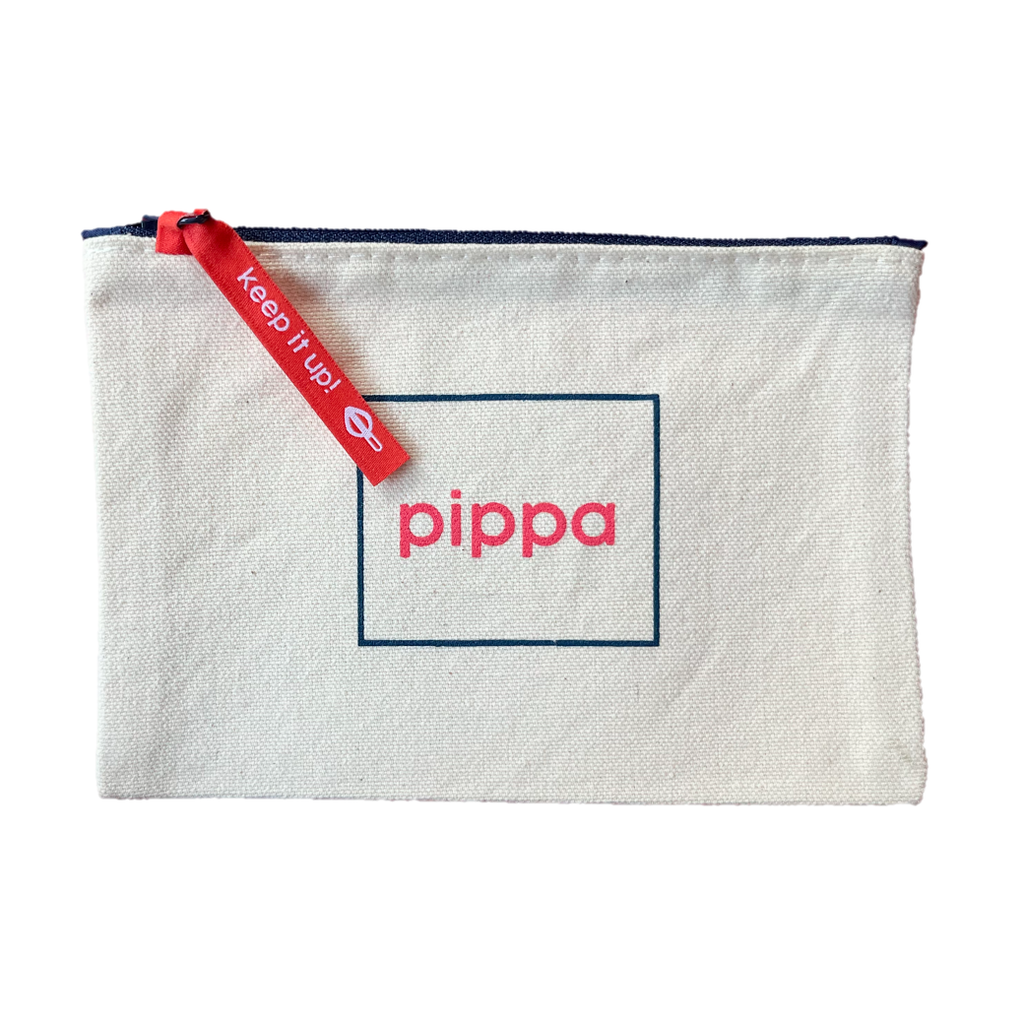 Rectangular white canvas pouch with dark blue zipper at the top. The pouch features a simple, centered graphic of "pippa" in the brand's red-pink color centered inside a dark blue rectangular outline. A pink-red woven zipper pull reads "keep it up" and has a Pippa resistance silhouette in white thread.